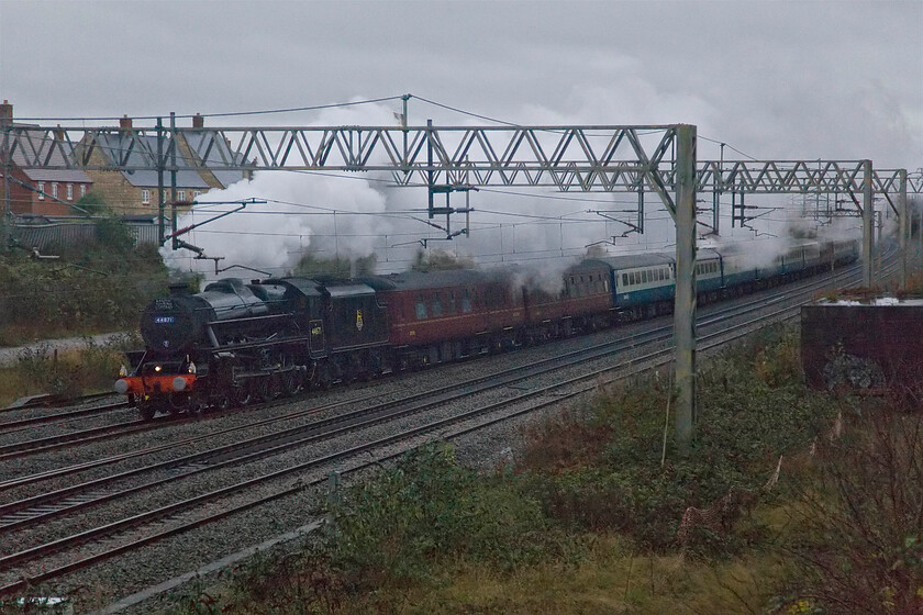 44871, outward leg of The Cheshireman, 06.51 London Euston-Chester (1Z71, 1L), site of Roade station 
 Black 5 44871 is in demand at the moment on railtour duties. Last Saturday it was captured on the ECML at Tempsford, see..... https://www.ontheupfast.com/p/21936chg/30062618742/x44871-christmas-white-rose-07-38 and here it is now on the WCML. In dreadful light and with storm Bert fast approaching the 06.51 Euston to Chester Cheshireman charter passes Roade with 47812 out of sight on the rear. In the cold and wet air the exhaust has certainly livened up the ridiculously dull scene! 
 Keywords: 44871 The Cheshireman 06.51 London Euston-Chester 1Z71 site of Roade station Black 5