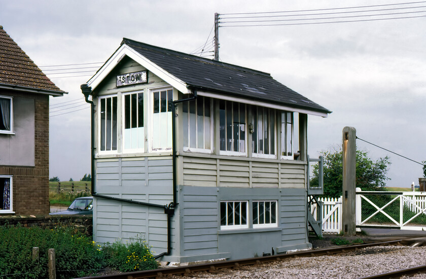 Stow signal box (GE, c.1881) 
 Wearing its shortened name of Stow the correct and full name of this Great Eastern c.1881 box should be Stow Bardolph located between Magdalen Road and Downham Market. The box was a crossing box on a very quiet road to the village of Stow Bridge. It closed in 1992 when the crossing was automated. Notice the unequal size of the roof with the front pitch having a deep overhang whilst the rear one does not; I wonder what the reason for this design was. 
 Keywords: Stow signal box GE Gret Eastern Railway