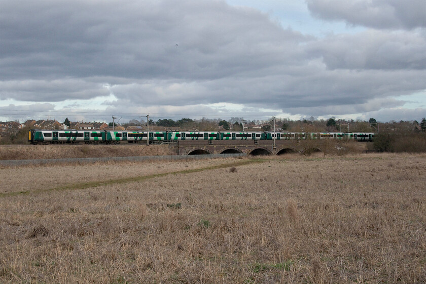 Class 350s, LN 14.38 Northampton-Birmingham New Street (2Y67, 4L), Kingsthorpe SP737635 
 With the houses of Kingsthorpe in the background to the north of Northampton a pair of London Midland Desiros head north working the 2Y67 14.38 Northampton to Birmingham service. The five-arch viaduct carries the line over Kingsthorpe Brook that is a tributary of the River Nene (pronounced locally as Nen) that it joins in the middle of Northampton between the Carlsberg brewery and B&Q! 
 Keywords: Class 350s 14.38 Northampton-Birmingham New Street 2Y67 Kingsthorpe SP737635 London Midland Desiro