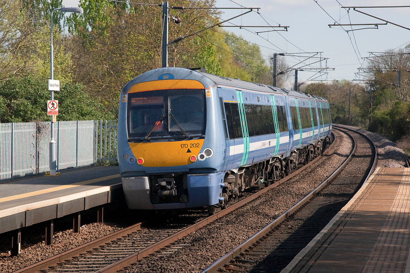 170202, GA 14.44 Cambridge-Ipswich (2W21,RT), Needham Market station 
 170202 leaves Needham market station forming the 14.44 GA working from Cambridge to Ipswich. As with most of the units working these services, we saw them more than once during the day, this one we observed at Elmswell, Kennett and Newmarket. 
 Keywords: 170202 2W21 Needham Market station