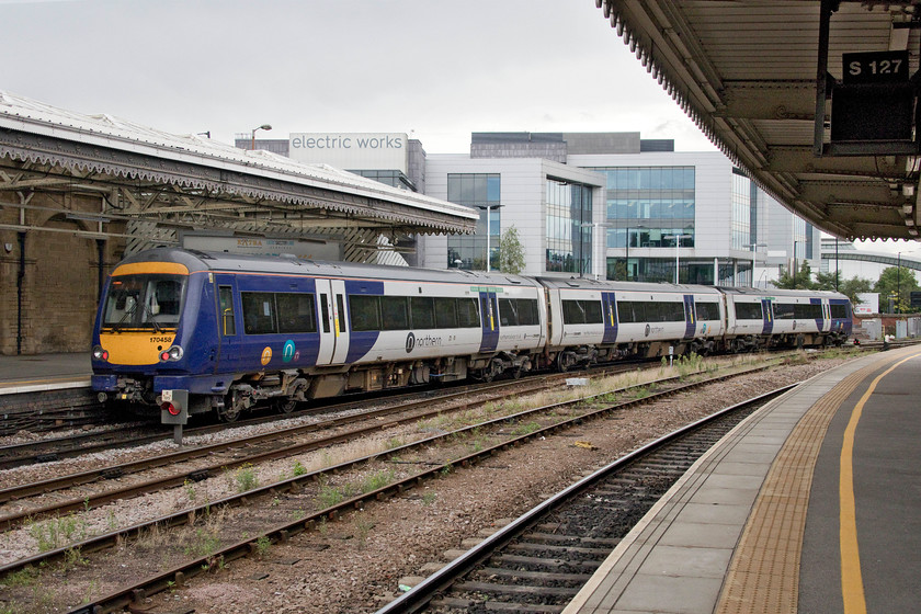 170458, NT 11.57 Sheffield-Hull (1W44, 1E), Sheffield station 
 The cascading of stock from operator to operator seems to be a constant process at the moment with the continual introduction of new trains releasing older stock enabling it to go elsewhere. The last time I saw 170458 it was standing on Edinburgh Waverley back in 2016, see...... https://www.ontheupfast.com/p/21936chg/25778314204/x334020-10-37-edinburgh-waverley Now, wearing Northern's new livery, it is seen leaving Sheffield working the 11.57 to Hull. 
 Keywords: 170458 11.57 Sheffield-Hull 1W44 Sheffield station Northern