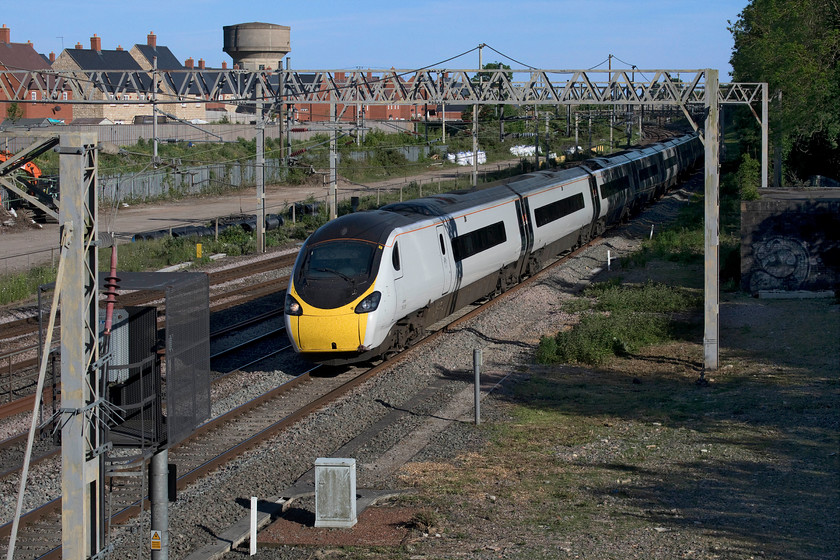 390008, VT 17.23 London Euston-Birmingham New Street (9G35, 1L), site of Roade station 
 390009 'Charles Rennie Mackintosh' passes Roade in lovely early evening sunshine working the 17.23 Euston to Birmingham New Street. Interestingly, just a very short distance from where I am standing is a cottage named Candidia (after George Bernard Shaw's play). It was completely remodelled from two smaller cottages during the end of World War One by the local entrepreneur and renowned model railway builder WJ Bassett-Lowke who was good friends with Charles Rennie Mackintosh. Rennie Mackintosh had a great deal of influence upon the design, fixtures and fittings of the cottage that later featured in an edition of Ideal Home magazine during 1920. Some of the original Rennie Mackintosh furniture from the cottage can be seen today at the Brighton Museum and Art Gallery. See..... https://www.brightontoymuseum.co.uk/index/File:Furniture_by_Charles_Rennie_Mackintosh_for_WJ_Bassett-Lowke.jpg 
 Keywords: 390008 17.23 London Euston-Birmingham New Street 9G35 site of Roade station Avanti West Coast Pendolino Charles Rennie Mackintosh