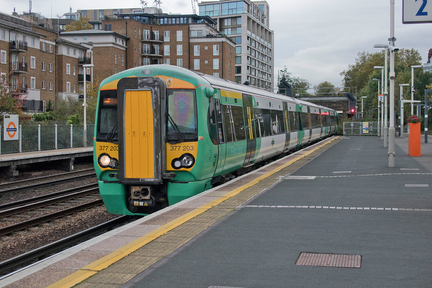 377203, SN 14.10 South Croydon-Milton Keynes Central (2M39, 2L), Kensington Olympia station 
 Our train home from London drifts into Kensington Olympia station. 377203 is working the 14.10 South Croydon to Milton Keynes Central that we took to its destination. Despite it being the middle of the afternoon before the peak period, the train was pleasingly full justifying its two-unit formation. Having said this, the return service from Milton Keynes in the early evening would be much busier. 
 Keywords: 377203 southern 14.10 South Croydon-Milton Keynes Central 2M39 Kensington Olympia station