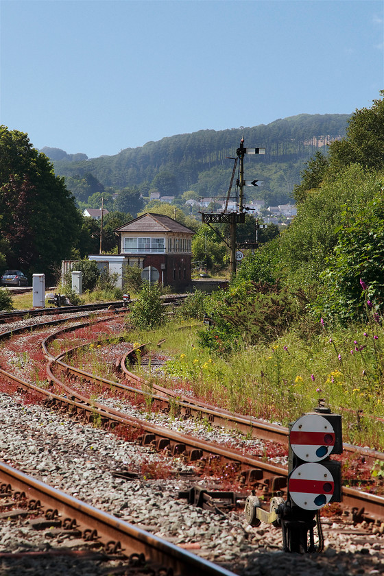 St. Blazey Junction signal box (GW, 1908) 
 This is the closest that I could get to St. Blazey Junction signal box. Up until rampant tree growth a picture could be taken from the path by the side of the stream directly in front of the box. Built in 1908 by the Great Western, it is a type 7d box that looks to be in good condition. It controls the sidings in the area as well as access to the old depot area. It also retains its block instruments for trains heading to Newquay as far as Goonbarrow, a winding and slow five miles away. The platform of the former St. Blazey station that closed very early in 1925 can just be seen behind the box. 
 Keywords: St. Blazey Junction signal box