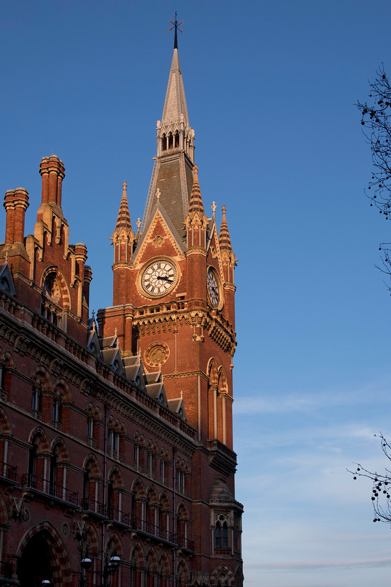 Clock tower, London St 
 In beautiful winter sunshine, the clock tower of Sir George Gilbert Scott designed Midland Grand hotel is seen keeping correct time according to my camera's timecode. The hotel, that was built after William Henry Barlow's better-known trainshed opened, was opened in 1873 and represented the last thing in Victorian opulence. The hotel building is primarily of polychromatic brick construction and in a style derived from the Italian gothic. Could you ever consider a situation where the hotel and the conjoined station could be demolished as was seriously being considered by BR in the 1970s? 
 Keywords: Clock tower London St. Pancras station Sir George Gilbert Scott