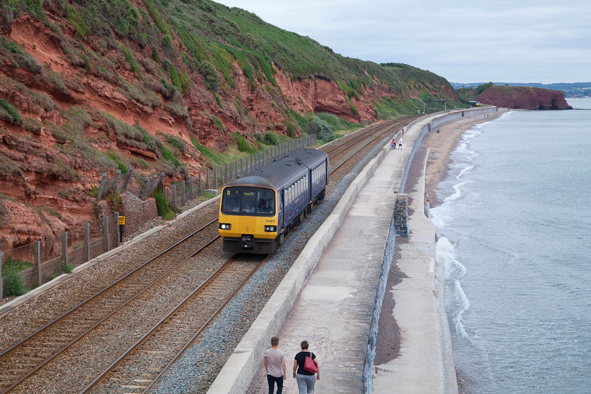 143317, GW 15.24 Exmouth-Paignton (2T21, 1L), Dawlish SX971773 
 143317 makes its way sedately along the sea wall preparing for its stop at Dawlish station, a short distance behind me. The Pacer started its journey for Paignton at 15.24 from Exmouth that can be seen directly behind Langstone Rock to the top right across the Exe Estuary. 
 Keywords: 143317 2T21 Dawlish SX971773