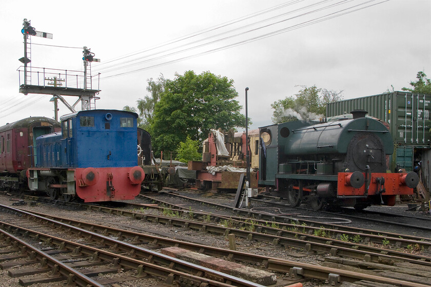 764 & 2104, stabled & serviced, Pitsford sidings 
 The sidings and yard at Pitsford on the Northampton and Lamport Railway is a busy place! To the left is Ruston and Hornsby 764 'Sir Gyles Isham' that I have just driven as part of my driver experience event. To the right is 0-4-0 Peckett 2104 that is being serviced and watered following its use earlier in the day hauling trains on the line. 
 Keywords: 764 2104 stabled serviced Pitsford sidings Ruston & Hornsby 0-4-0 165DS Sir Gyles Isham 0-4-0ST Peckett R4 Class