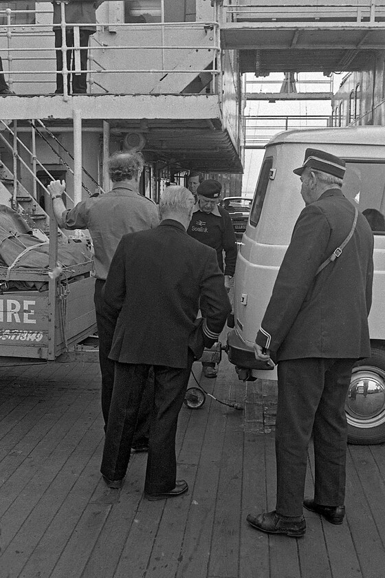 Loading MV Farringford, New Holland Pier 
 Crew members aboard the MV Farringford appear to be in discussions as to the best way to un-hitch the substantial and well-loaded trailer from the rear of a smart looking (probably pretty new at this time before the scabby rot set in!) Sherpa minibus. Once un-hitched the trailer will be manoeuvred into a suitable corner of the deck and the minibus parked up to permit other vehicles to board to make the journey across the Humber estuary to Hull. 
 Keywords: Loading MV Farringford New Holland Pier Sealink