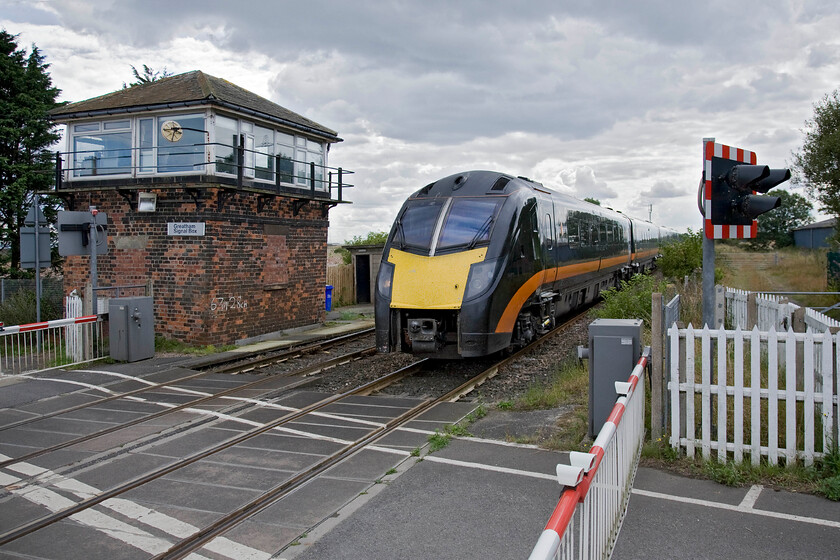 Class 180, GC 11.21 London King's Cross-Sunderland (1N92), Greatham crossing 
 Looking south-west at Greatham level crossing sees Grand Centrals 11.21 Kings Cross to Sunderland service passing at some speed towards the end of its journey from London. The train is passing the doomed 1899 North Eastern Railway signal box that is to shut in the coming few years as modernisation finally catches up with the Durham Coast route! 
 Keywords: Class 180 11.21 London King's Cross-Sunderland 1N92 Greatham crossing Grand Central