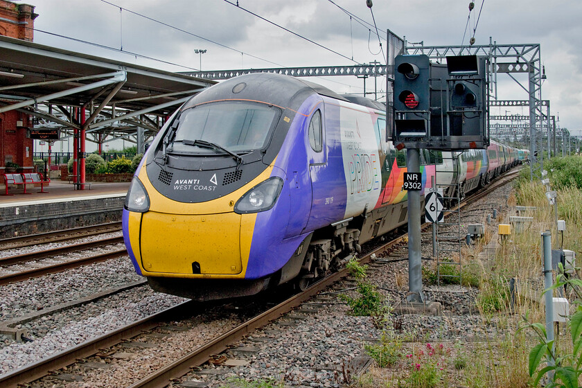 390119, VT 11.40 London Euston-Birmingham New Street (9G08, RT), Rugby station 
 I have been attempting to photograph 390119 'Progress' since it was vinyl wrapped and named last year on 11.10.20. always appearing to have just missed it! Here it arrives at Rugby station with the 11.40 Euston to Birmingham New Street service. I have seen some awful and bigoted comments on social media from so-called railway 'enthusiasts' about the work done to this Pendolino with lines such as 'we don't want this ramming down our throats'. My message to these zealots is, don't look at this Pendolino when it races past you and don't take any photographs if a brightly coloured train offends you! 
 Keywords: 390119 11.40 London Euston-Birmingham New Street 9G08 Rugby station Avanti West Coast Pendolino Progress