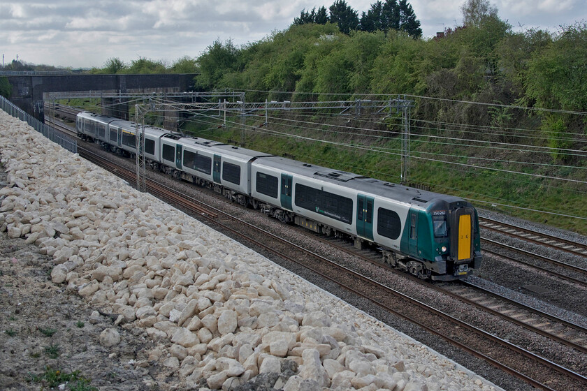 350267, LN 08.24 London Euston-Birmingham New Street (2Y40, 2L), Ashton Raod bridge 
 A brand new location and a stone's throw from home! Now that the work has been completed to stabilise the embankment and that the contractors have handed back the site this view looking south is possible with a view to the north also available. With the Ashton Road bridge in the background 350267 heads north working the 08.24 Euston to Birmingham New Street train. I have discovered that taking photographs around this location that includes large areas of the rock armour that has been installed causes problems with the camera. It seems to confuse the automatic exposure 'brain' causing the photograph to be grossly underexposed with the stone being correctly exposed. Luckily, in most cases, Photoshop has been able to resurrect the image but I will need to use manual exposure mode in the future and settle for a compromise setting that is easier to fettle later on. 
 Keywords: 350267 08.24 London Euston-Birmingham New Street 2Y40 Ashton Road bridge London North Western Desiro