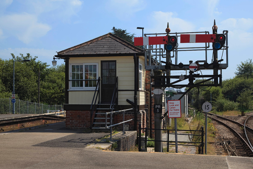 Par signal box (GW, c1879) 
 Par signal box sits at the end of the platform at the station. It was doubled in length in 1893 and a new frame installed. It controls an extensive are of the Great Western mainline as far as Truro to the west and Lostwithial to the east. It also controls access to the Newuqay branch that can bee seen curving off to the right in this picture. It is a listed building so it should live on after re-signalling renders it redundant. 
 Keywords: Par signal box