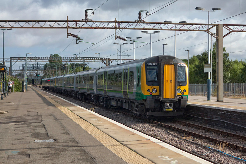 350129, LN 08.16 Northampton-Birmingham New Street (2Y63, RT), Northampton station 
 350129 and one of its stablemates leaves one of Northampton's bay platforms with the 08.16 to Birmingham New Street. After weeks of hot and dry weather it had rained the previous night and the temperature was considerably cooler and for the first time in quite a while I wore a jacket! 
 Keywords: 350129 2Y63 Northampton station