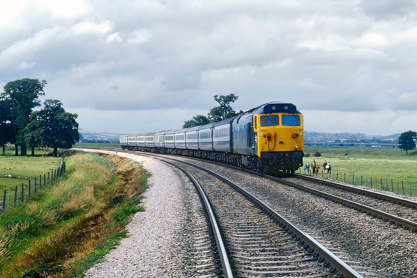 50047, 13.30 London Paddington-Penzance (1B52), Powderham SX972848 
 Not actually a trespass shot but, in hindsight not an ideal location unless I had eyes in the back of my head! Taken from a public footpath crossing near Powderham, 50047 'Swiftsure' speeds westward with the 13.30 London Paddington to Penzance. I wonder if the family out for their walk appreciated the scene as much as I did? This public crossing has now been replaced by a gargantuan bridge for walkers, cyclists and horse riders using the Exe Valley Way. On the hill behind 50047, the city of Exeter can be seen. 
 Keywords: 50047 13.30 London Paddington-Penzance 1B52 Powderham SX972848