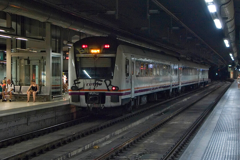 Class 448, Renfe unidentified working from Barcelona-Sants, Barcelona-Sants station 
 It's comforting to see that Spanish railways also suffer from the scourge of the graffiti vandal. A daubed Renfe Class 448 stands in the darkness of Barcelona's Sants station waiting to leave with an unidentified service. before the squadron introduction of high-speed services these slab-fronted units were used on inter-city services but have now been put to use on regional services for which I suspect they are far better suited. 
 Keywords: Class 448 Renfe unidentified working from Barcelona-Sants Barcelona-Sants station