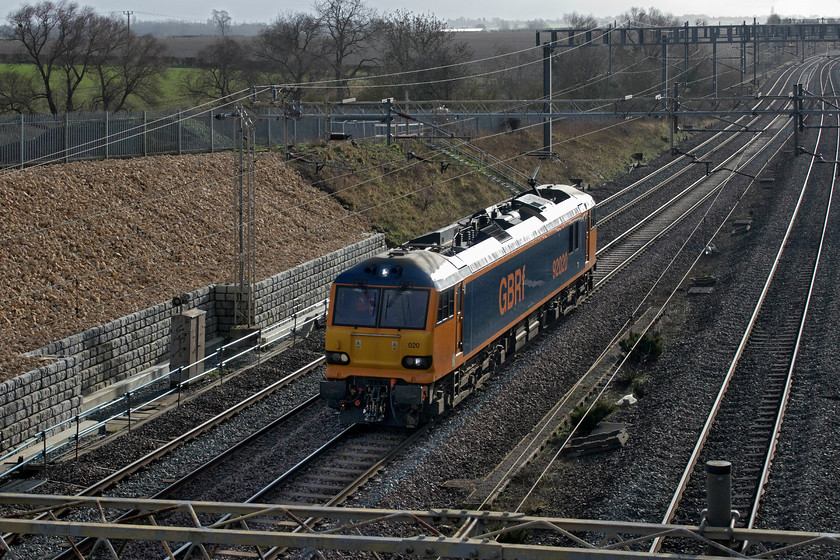 92020, 09.10 Wembley IC depot-Polmadie (0Z92, 25E), Ashton Road bridge (closed) 
 With almost empty lines on a Sunday morning, the 09.10 Wembley IC depot to Polmadie light engine move made very rapid progress on the first part of its journey north. It nearly caught me unawares as it approached silently giving me just enough time to wrench my gloves off and raise the camera over the parapet of the bridge with the viewing screen facing me and hoping for the best! Luckily, it all came together and a reasonable photograph of 92020 in its smart GBRf livery resulted. 
 Keywords: 92020 09.10 Wembley IC depot-Polmadie 0Z92 Ashton Road bridge closed GBRf Caledonian Sleeper