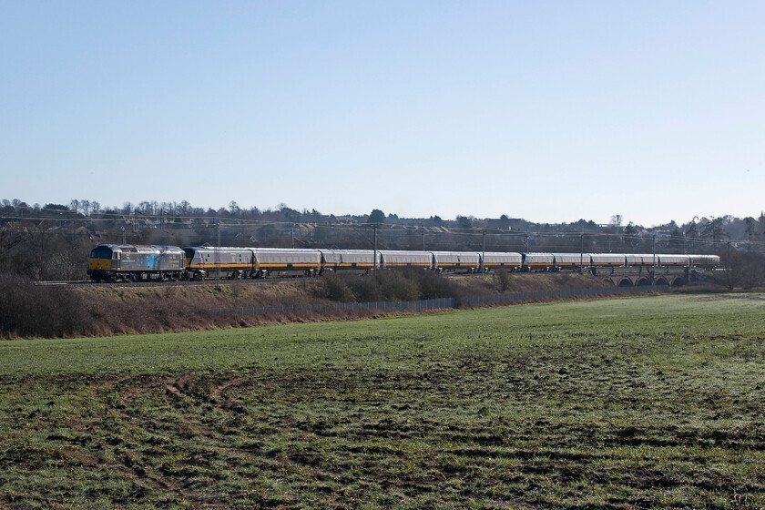 47812, 06.44 Eastleigh Arlington-Worksop Down Reception (5Q26), Wilson's Crossing 
 With the sun's low angle creating a few lighting issues at Wilson's Crossing just north of Northampton, this interesting working led by Rail Operation Group's 47812 gets away from the town. Andy and I had arrived at this location and were following the progress of 5Q26 but knew very little about it as the operator had obfuscated it meaning no progress was indicated on RTT or Rail Record. The 06.44 Eastleigh Arlington to Worksop Down Reception was conveying two superbly painted Grand Central sets of stock for further storage. The TOC had ambitious plans to operate Blackpool to Euston trains starting last September but COVID put an end to all of that! 
 Keywords: 47812 06.44 Eastleigh Arlington-Worksop Down Reception 5Q26 Wilson's Crossing ROG Rail Operation Group Grand Central GC