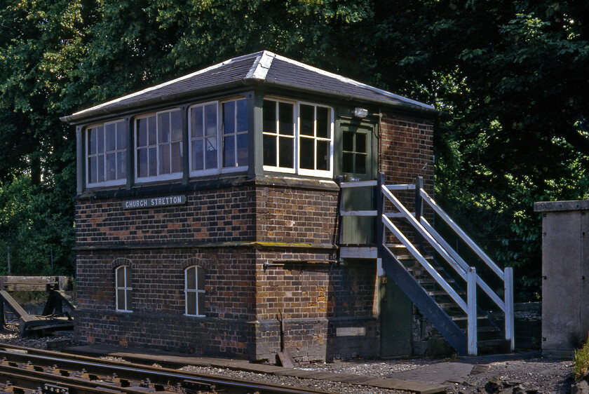 Church Stretton signal box (LNW & GW Joint c. 1872) 
 Rather shaded from the strong August afternoon sunshine Church Stretton signal box is seen on the platform end. Another lovely example of a LNW & GW joint box dating, as per a number of the others, from 1872. This box was permanently switched out of circuit in 2003. It sat empty, unused and deteriorating until it was dismantled in the spring of 2009 and rebuilt in a nearby park but I have yet to see any further information or images of this. 
 Keywords: Church Stretton signal box LNW & GW Joint 1872)