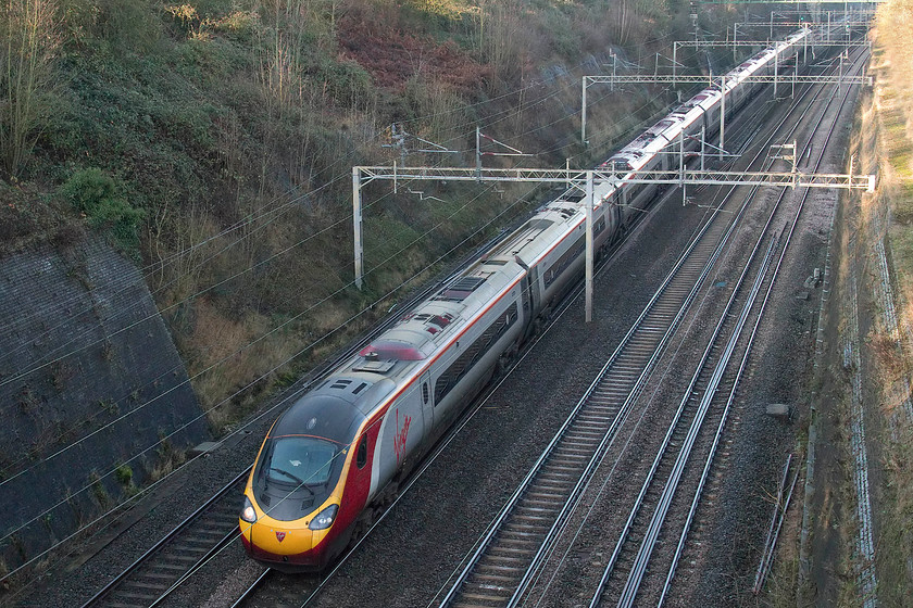 390129, VT 11.47 Liverpool Lime Street-London Euston (1A30, 1E), Roade Cutting 
 In the shady depths of Roade Cutting, 390129 'City of Stoke-on-Trent' is seen working the 1A30 11.47 Liverpool Lime Street to Euston. 
 Keywords: 390129 11.47 Liverpool Lime Street-London Euston 1A30 Roade Cutting