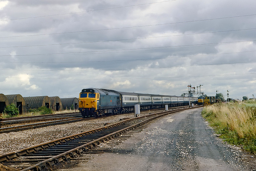 50029, 11.30 London Paddington-Penzance, Silk Mill 
 In Tauntons Fairwater Yard, a Peak waits for the road whilst the resident departmental class 03 shunter goes about its business. Having reached Paddington earlier in the day, 50029 'Renown' returns on the down Cornish Riviera. This was one the few remaining titled trains on the BR network. Leaving Paddington at 11.30, it ran non-stop to Exeter St. Davids thence on to Penzance with a scheduled arrival time of 17.07. The World War Two era Nissen huts, that were such a noticeable feature of this section of track to the west of Taunton, are clearly seen here, they have long gone now to be replaced by the Binden Road industrial park. 
 Keywords: 50029 11.30 London Paddington-Penzance Silk Mill