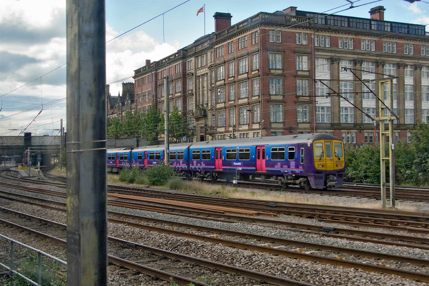 319366, stabled, Preston station 
 I would not normally have permitted this photograph to have made the final cut but it is an interesting subject so it has got away with it! It shows 319366 still wearing its First Capital Connect livery dating from 2006 with a crudely applied Thameslink vinyl on its flank. It is seen stabled just north of Preston station and probably awaiting its induction into a new life with Northern Trains. The impressive Queen Anne revival style building behind the stabled train is Lancashire County Hall. 
 Keywords: 319366 Preston station Thameslink