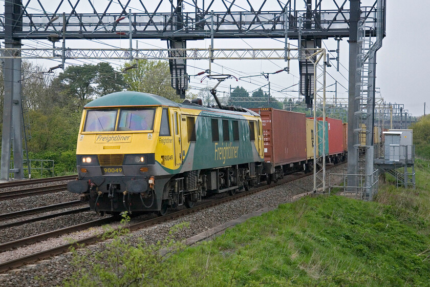 90049, 22.00 Coatbridge-Felixstowe North (4L89), Roade Hill 
 I was hoping that the 4L89 20.00 Coatbridge to Felixstowe North would be Class 86 hauled as it often is by a pair of locomotives. However, squeezing a pair of locomotives into the shot this side of the huge and somewhat over-engineered signal gantry would be tricky so I will take 90049 as an alternative! 
 Keywords: 90049 22.00 Coatbridge-Felixstowe North 4L89 Roade Hil Freightliner