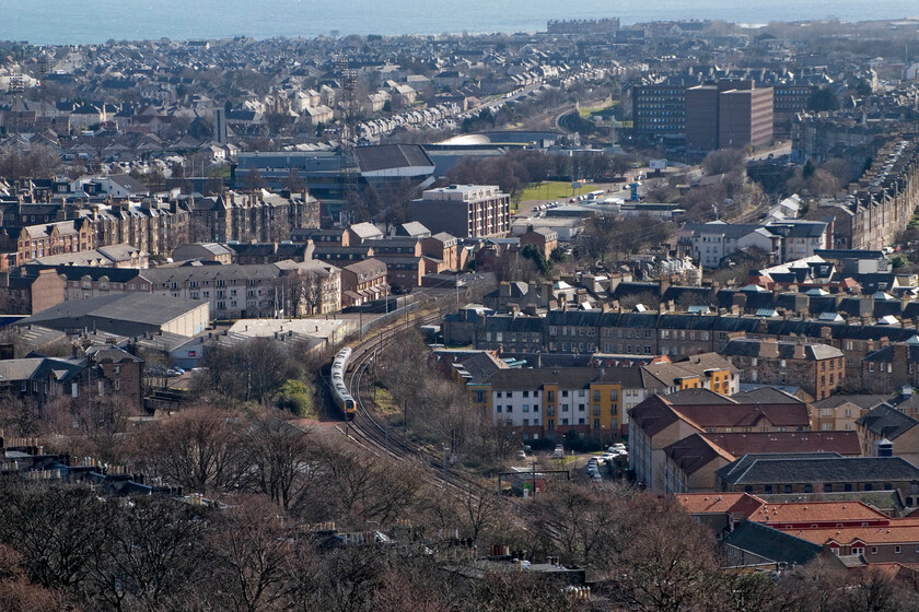 Class 221, XC 09.00 Glasgow Central-Penzance, Abbeyhill district of Edinburgh from Calton Hill 
 Taken from the lofty heights of Calton Hill that towers above the eastern end of Edinburgh an unidentified CrossCountry 221 leaves the city working the 09.00 Glasgow Central to Penzance service. Looking across the Abbeyhill district of Edinburgh reveals the large Meadowbank Stadium that hosted the Commonwealth Games in both 1970 and 1986. It is also the home to Edinburgh City FC. 
 Keywords: Class 221 09.00 Glasgow Central-Penzance Abbeyhill district of Edinburgh from Calton Hill Cross Country Voyager