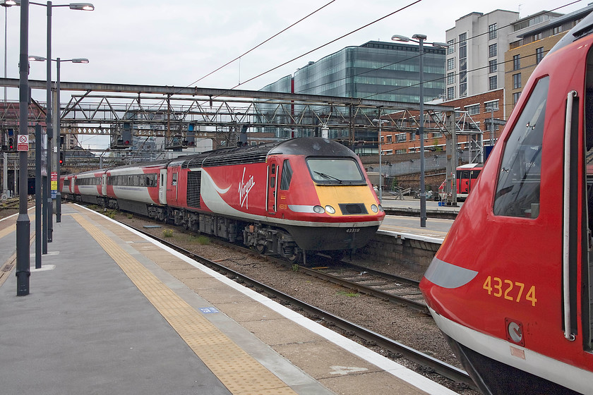 43318, GR 07.55 Inverness-London Kings Cross (1E13, 1E) & 43274, GR 16.00 London Kings Cross-Aberdeen (1S24, 1E), London Kings Cross Station 
 Two Anglo Scottish HSTs meet at King's Cross station. The only difference is that one is just arriving having completed its 566 mile journey as the 1E13 07.55 from Inverness with 43318 at the front. The other, with 43274 leading, is about to embark on its 523 mile journey, the 1S24 16.00 to Aberdeen. These forty year old HSTs are still quite capable of handling such demanding diagrams day in, day out, but for how much longer? 
 Keywords: 43318 1E13 43274 1S24 London Kings Cross Station