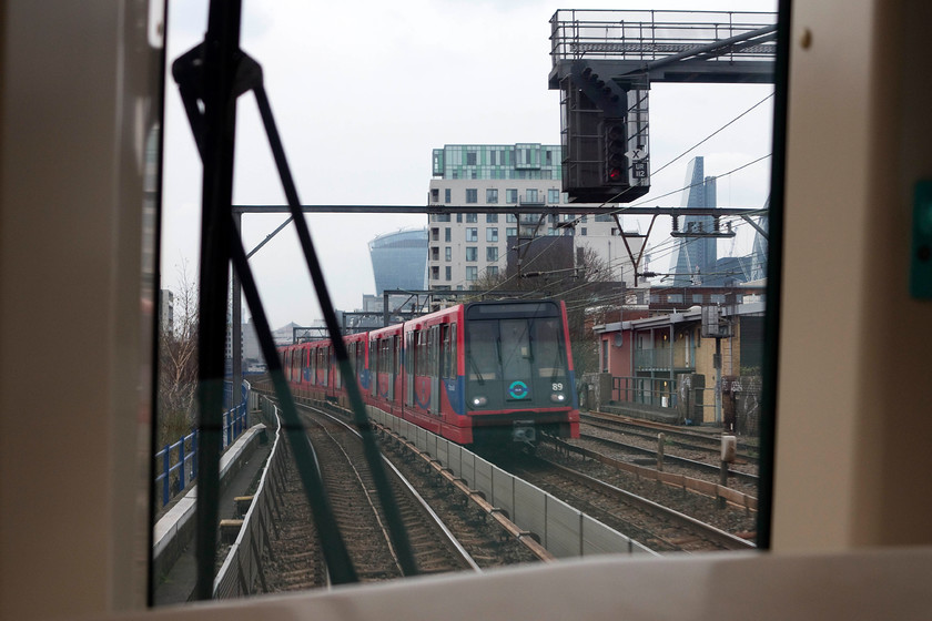 154, Lewisham-Bank working & 89, unidentified working, Shadwell 
 Taken from the front of set 154 a Lewsiham to Bank Docklands Light Railway waits at Shadwell station. Another DLR working is seen heading the other way formed by set 89.