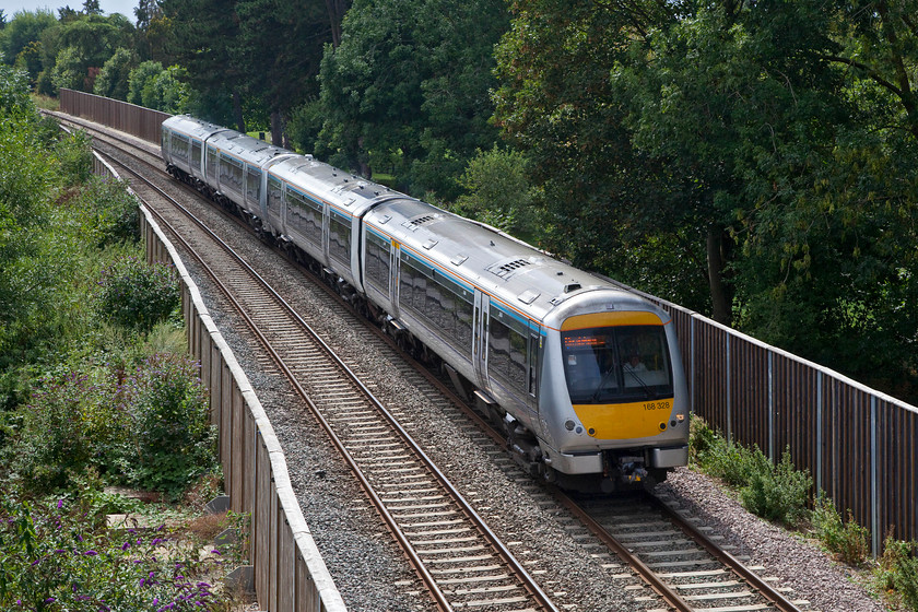 168328 & 168324, CH 14.42 Oxford-London Marylebone (1Y37, RT), Bicester Gavray Junction 
 168328 and 168324 approach the new Gavray Junction just west of Bicester working the 14.42 Oxford to London Marylebone. The picture is taken from the hugely controversial Tubbs Crossing footbridge. It's an absolute monster of a structure that towers above the local houses and most controversially a day nursery affording full views in. Whilst I was there, it had appeared to have become a play structure for local youngsters. 
 Keywords: 168328 168324 1Y37 Bicester Gavray Junction