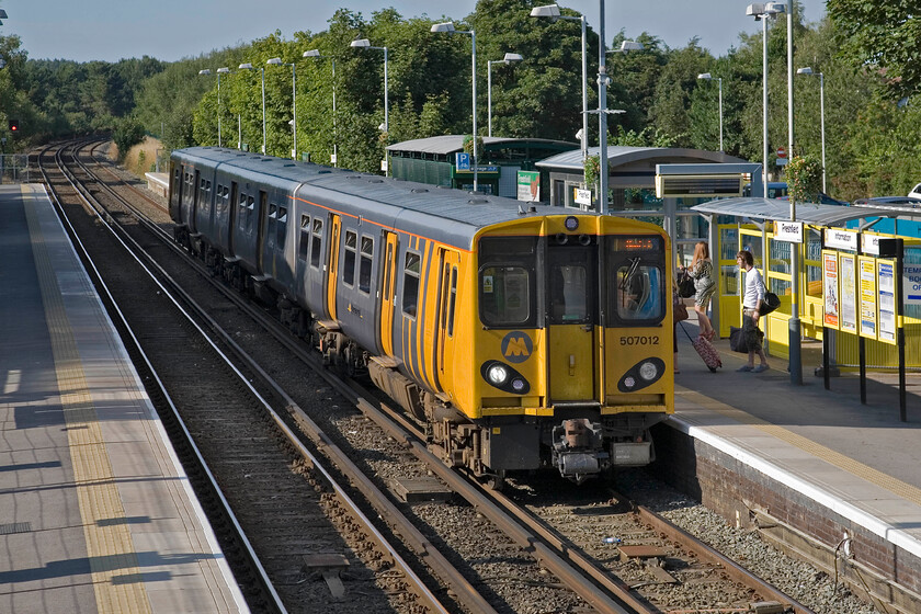 507012, ME 17.28 Southport-Hunts Cross, Freshfield station 
 In glorious evening light, the 17.28 Southport to Hunts Cross service arrives at Freshfield station. These venerable units are now thirty-five years old and have given superb service over this time. However, replacements must be on their way pretty soon to satisfy the modern-day needs of Merseyside's travelling public, for example, by providing air conditioning. 
 Keywords: 507012 17.28 Southport-Hunts Cross Freshfield station Merseyrail