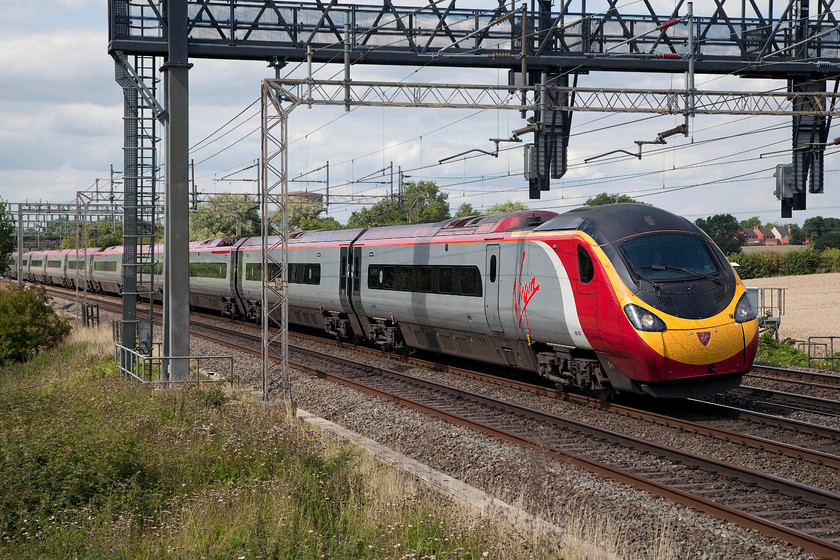 390131, VT 10.38 Glasgow Central-London Euston (1M07, 2L), Ashton Hill 
 390131 'City of Liverpool' races past Ashton Hill just south of Roade in Northamptonshire forming the 10.38 Glasgow Central to London Euston. Despite the cloudy skies, I was rewarded with a small set of photographs with all of the subjects being in the sun! 
 Keywords: 39013 1M07 Ashton Hill