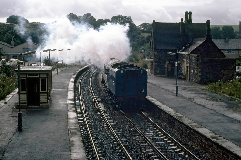 4498, Sellafield-Carnforth light engine, Dalton-in-Furness station 
 Having completed its railtour duties, 4498 'Sir Nigel Gresley' returns to Carnforth light engine from Sellafield. The locomotive is seen passing through Dalton-in-Furness station with the photograph taken from the former station footbridge that has now been removed. The station building still stands and has been tastefully restored from the boarded up state it is seen in here and is in private ownership. Unfortunately, the lovely waiting room on the platform has been replaced by a modern equivalent. 
 Keywords: 4498 Sellafield-Carnforth Dalton-in-Furness station