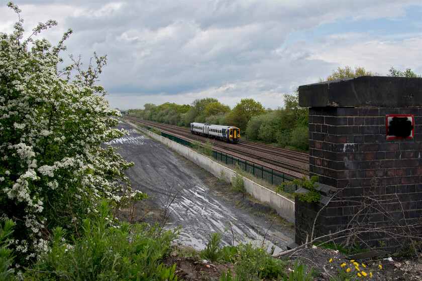 158789, NT 13.53 Hull-Doncaster (2C64, 11L), Cuckoo bridge SE660116 
 A wide-angle view from the oddly named Cukoo bridge near Stainforth sees 158789 approaching working the 13.53 Hull to Doncaster Northern service. Between the bridge abutment and the hawthorn (crataegus monogyna) is the vast area of heavily rutted and puddle filled flat land that was previously occupied by railway sidings in connection with the removal of coal from the site by rail. I am not as to why some vandal has painted out the bridge identification plate with black paint? 
 Keywords: 158789 13.53 Hull-Doncaster 2C64 Cuckoo bridge SE660116