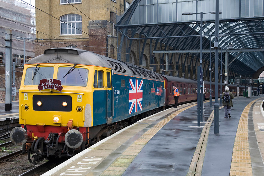 47580, outward leg of The Cathedrals Express, 09.11 London King's Cross-Shildon (1Z24), London King's Cross station 
 Having been dragged in at the rear of the empty coaching stock 47580 'County of Essex' is being prepared to lead the outward leg of The Cathedrals Express charter from King's Cross. 47580 has become a firm favourite with enthusiasts and charter operators alike due to its striking appearance in BR Monastral Blue and now adorned with a huge union flag. However, it does seem a shame that the owners could not have touched in the large area of filler on the corner of cab front with a pot of yellow paint! 
 Keywords: 47580 outward leg of The Cathedrals Express 09.11 London King's Cross-Shildon 1Z24 London King's Cross station County of Essex