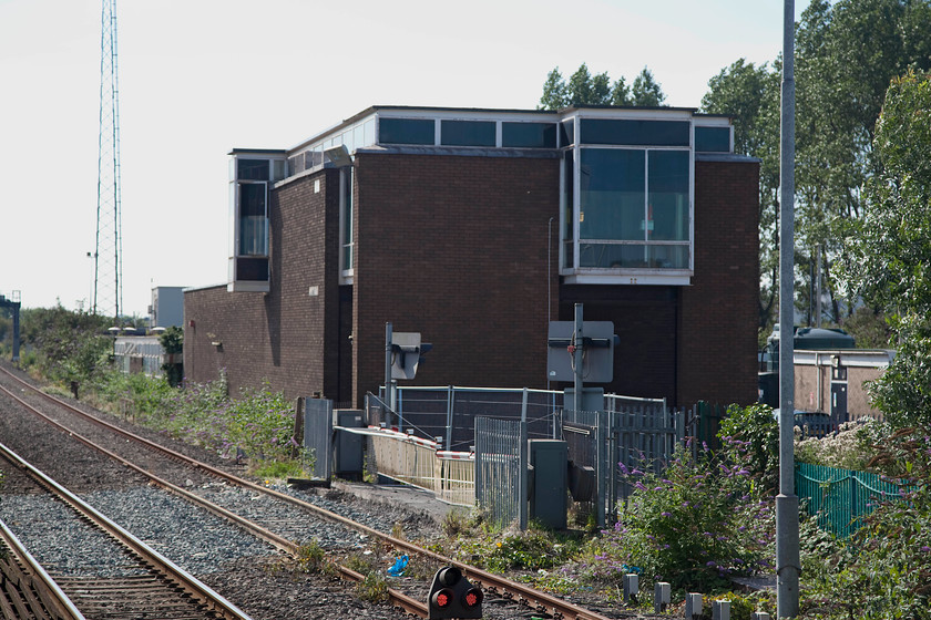 Port Talbot signal box (BR, 1963) 
 Not one of BR's finest structures but one of historical note none-the-less. Port Talbot PSB was opened in 1963 when it replaced a number of boxes on the South Wales mainline. However, time is now up for this relatively new box and, I believe that it is about (or it has already?) close. Notice the level crossing that has been recently closed as Port Talbot's shiny new station opened that I am standing on the end of to take this picture. Andy and I took a break at Port Talbot, taking a very satisfying breakfast in a huge Morrisons supermarket; very good value too! 
 Keywords: Port Talbot signal box