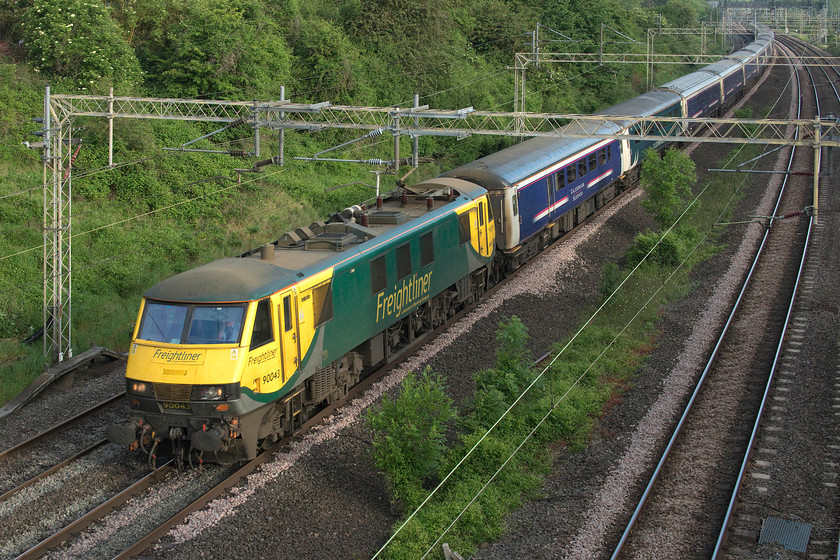 90043, CS 19.50 Fort William, 21.043 Aberdeen, 20.45 Inverness-London Euston (1M16, 4E), Victoria bridge 
 This could possibly be the last Caledonian Sleeper service to use the aging Mk. III stock with the even older Mk. II day stock. CS was scheduled to turn this service over to the new CAF Mk. IV stock from the following Monday, as the lowland service had done some weeks earlier. 90043 brings the 1M16 past Victoria bridge between Roade and Ashton on the southern WCML.

*UPDATE* ...........
It has emerged that this WAS supposed to have been the final Mk. III sleeper train but due to mileage accumulation issues and shunting logistics problems at Edinburgh, there will be another month with this stock in use before the Mk. Vs come into use. 
 Keywords: 90043 19.50 Fort William 21.043 Aberdeen 20.45 Inverness-London Euston 1M16 Victoria bridge