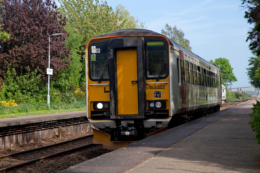 153322, LE 14.57 Lowestoft-Norwich (2J812, 1L), Cantley station 
 Single car 153322 rattles through Cantley station in the heart of the Wherry Lines network with the 14.57 Lowestoft to Norwich working. Cantley signal box can just be seen behind the single-car unit as can the conveyer bridge that is part of the vast Cantley sugar beat refinery. 
 Keywords: 153322 2J812 Cantley station