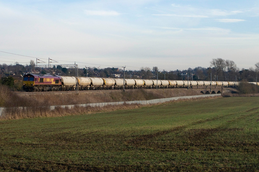 66154, 13.01 Willesden Eurotunnel-Tunstead (6H50), Wilson`s crossing 
 EWS branded 66154 makes relatively light work of the 6H50 13.01 Willesden Eurotunnel to Tunstead empty cement wagons. It is seen climbing away from Northampton past Kingsthorpe. Unfortunately, I under estimated the length of the train and the final cement wagons are out of shot to the right. 
 Keywords: 66154 13.01 Willesden Eurotunnel-Tunstead 6H50 Wilson`s crossing