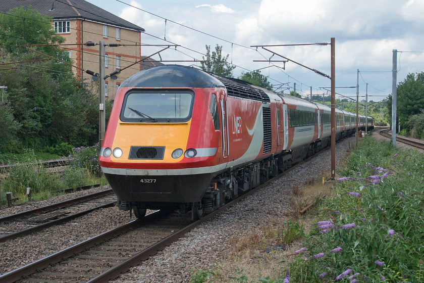 43277, GR 12.02 York-London King`s Cross (1Y84, 9L), New Barnet station 
 43277 leads the 12.02 York to King's Cross service through the north London suburbs at New Barnet. Once again, the sun has spoilt the occasion with the back end of the train in brighter light than the front! New Barnet was not the most attractive of stations that once again had the fast line platforms fenced off preventing access by the public with locked gates for emergency use. 43277 (origonally as 43077) has always been an ECML power car being delivered in 1978 as part of set 254011. 
 Keywords: 43277 12.02 York-London King`s Cross 1Y84 New Barnet station