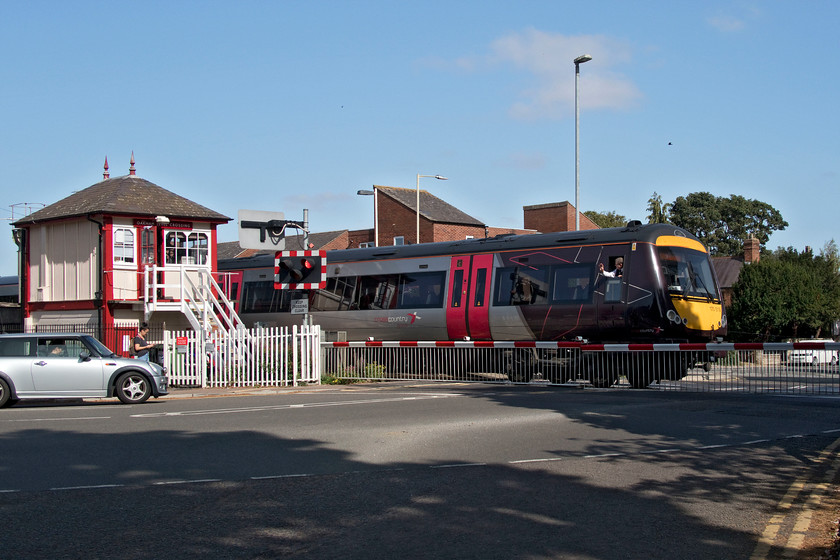 170519, XC 11.00 Cambridge-Birmingham New Street (1N51, 67L), Oakham level crossing 
 With a cheery wave from the guard to the signalman the 11.00 Cambridge to Birmingham New Street service enters Oakham station over an hour late. It was reported to us by the crossing keeper at Uffington that a freight had, in his words, 'broken down' near Ely earlier in the morning. Certainly, all services coming from that area were incredibly delayed. Apart from a change of colour and some updating, the signal box looks very similar to when I first saw and photographed it back on a dark and dismal day in November 1985. Incidentally, Oakham signal box was used by Airfix to model their prototype model for their 1960s construction kits. 
 Keywords: 170519 11.00 Cambridge-Birmingham New Street 1N51 Oakham level crossing Cross Country Trains