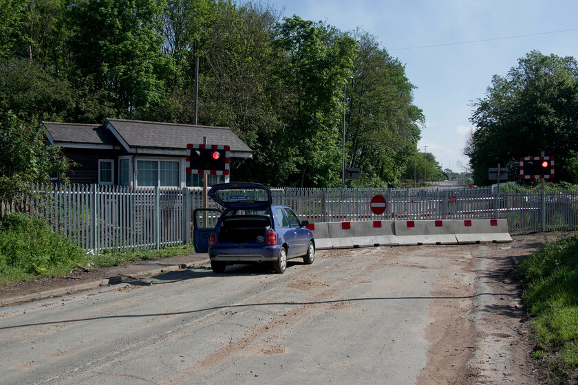 Former King's Dyke level crossing 
 I was keen to revisit King's Dyke level crossing following its closure last year with the opening of the new bridge just to the east of this spot. The road is seen now firmly truncated from both directions by palisade fencing and large bollards looking somewhat different to when I last visited, see.... https://www.ontheupfast.com/p/21936chg/28569144804/x43206-43006-04-41-craigentinny-ely. Interestingly, the lights still flash in perpetual anticipation of a train approaching. The box is still in use but the signalman's job is made somewhat easier now with him not having to close and open the gates. Just as an aside, the bridge that now carries the A605 over the line was already under repair with traffic lights in use slowing traffic once again rather like when the level crossing was still in use! 
 Keywords: Former King's Dyke level crossing