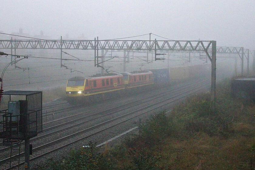 90004 & 90013, 02.50 Felixstowe North-Garston (4M45, 38E), site of Roade station 
 The light is abysmal with the combination of thick fog and it being before 08.00 on a mid-October morning. However, I like a challenge so I have presented this image of 90004 and 90013 leading the 4M45 02.50 Felixstowe to Garston Freightliner service and describing it as atmospheric! 
 Keywords: 90004 90013, 02.50 Felixstowe North-Garston 4M45 site of Roade station Freightliner