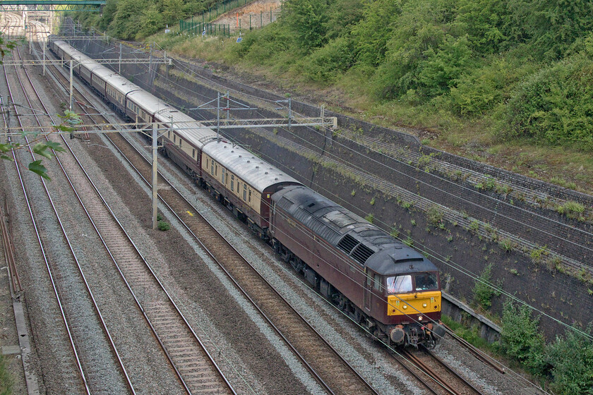 47804, 11.51 Northampton-Wolverton Centre Sidings (5Z63, 1L), Roade cutting 
 I am not at all sure as to why the empty coaching stock from the 1Z60 Grand Prix charter had to head north after depositing its passengers at Milton Keynes to then return to Wolverton Work's Centre Sidings for stabling? Why did the train not simply stay at Northampton or even reverse into Milton Keynes' rarely used south-facing platform 2A? However, this did give an extra opportunity to photograph the train passing through Roade seen here deep in the cutting as the 5Z63 11.51 ex Northampton with 47804 leading. 
 Keywords: 47804 11.51 Northampton-Wolverton Centre Sidings 5Z63 Roade cutting