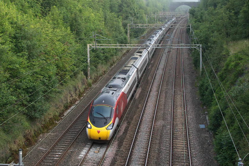 390126, VT 05.54 Wolverhampton-London Euston (1B02, 10L), Hyde Road bridge 
 On a misty morning, 390126 heads south past Roade forming the 05.54 Wolverhampton to London Euston. The photograph is taken from Hyde Road bridge in the village, one of a number of places that the railway is crossed within a short distance. 
 Keywords: 390126 05.54 Wolverhampton-London Euston 1B02 Hyde Road bridge