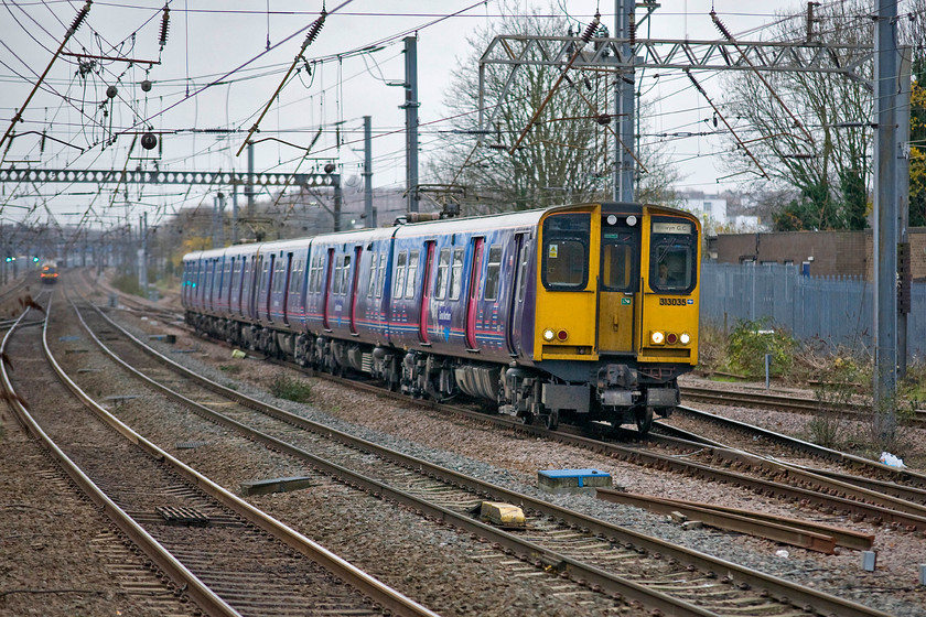 313035, GN 08.41 London King's Cross-Welwyn Garden City (2V14), Alexandra Palace station 
 313035 and another unit approach Alexandra Palace working the 08.41 King's Cross to Welwyn Garden City 2V14 service. These elderly units dating from 1976/7 are due to be replaced in the coming few years as new stock is introduced improving the lot of London travellers. 
 Keywords: 313035 08.41 London King's Cross-Welwyn Garden City (2V14), Alexandra Palace station GN Great Northern