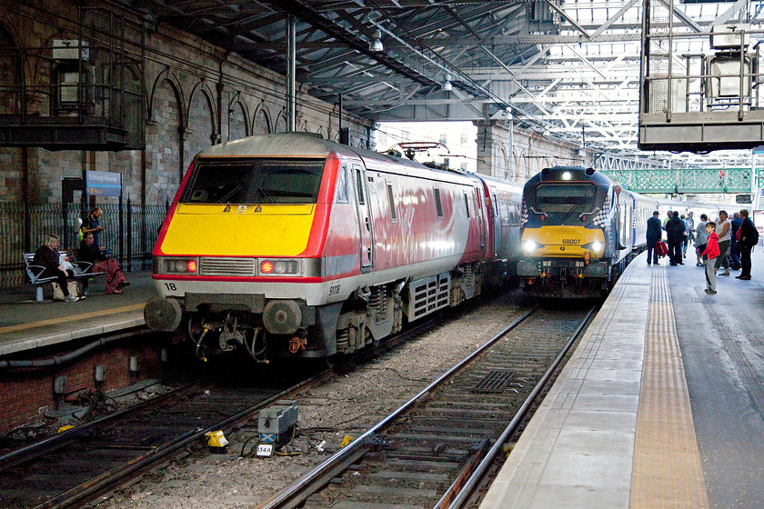 91118, GR 11.30 London King`s Cross-Edinburgh (1S15) & 68007, SR 17.20 Edinburgh Waverley-Cardenden ( 2L69), Edinburgh Waverley station 
 The second evening commuter 'super train' arrives into Edinburgh Waverley hauled by 68007 'Valiant'. This 2L69 service is the 17.20 Waverley to Cardenden that goes via Dunfermline. Once it reaches its destination, it takes a leisurely return journey as ECS to Mossend. As it arrives at Waverley, 91118 has just arrived leading the 11.30 from London King's Cross. 
 Keywords: 91118 11.30 London King`s Cross-Edinburgh 1S15 68007 17.20 Edinburgh Waverley-Cardenden 2L69 Edinburgh Waverley station