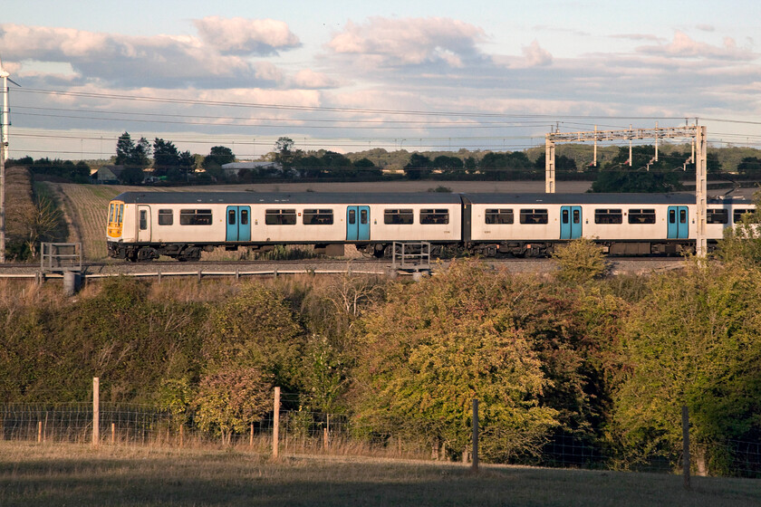 319215 LN, 18.05 Northampton-London Euston (2N94, 1L), Roade hill 
 I have it on good authority that London Northwestern is planning to dispense with their few remaining Class 319s next Month (October 2022). They have operated a small number, that usually work in multiple, on morning and evening commuter services with many associated empty stock moves between Bletchley and Northampton with them never going further north than the latter. The rear of 319215 in its plain and unbranded livery passes Roade hill heading south with the 18.05 Northampton to Euston service. 
 Keywords: 319215 18.05 Northampton-London Euston 2N94 Roade hill London Northwestern