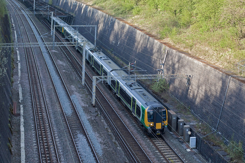 350241, LM 15.54 Birmingham New Street-London Euston (2Y16, RT), Roade Cutting 
 I have to admit that I got my sums wrong here! I figured that the sun would still be high enough to be in the cutting but I was but by about half an hour! 350241 emerges from under the Roade Cutting 'bird cage' as it is referred to. The Desiro is working the 2Y16 15.54 Birmingham new Street to London Euston. 
 Keywords: 350241 2Y16 Roade Cutting