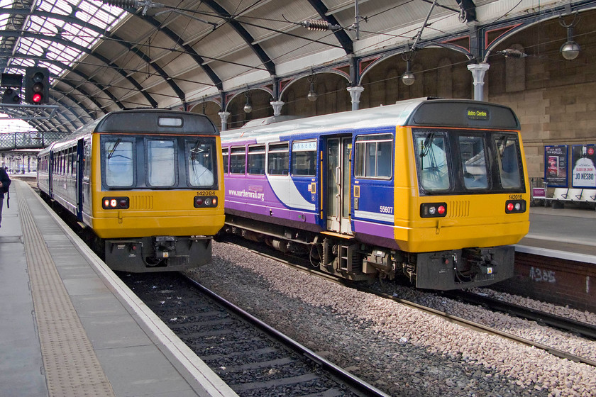 142084, NT 15.02 Metrocentre-Morpeth (2A22) & 142016, NT 14.49 Morpeth-Metrocentre (2A15), Newcastle station 
 A meeting of reversed services at Newcastle Central station but with very few passengers in evidence. To the left, the 15.02 Metrocentre to Morpeth service is worked by Pacer 142084 whilst, to the right the 14.49 Morpeth to Metrocentre 2A15 service is formed from 142016. It is saying something about our modern-day world when there are back to back railway services operating to a shopping centre, even if it is the second largest in the UK. 
 Keywords: 142084 15.02 Metrocentre-Morpeth 2A22 142016 14.49 Morpeth-Metrocentre 2A15 Newcastle station